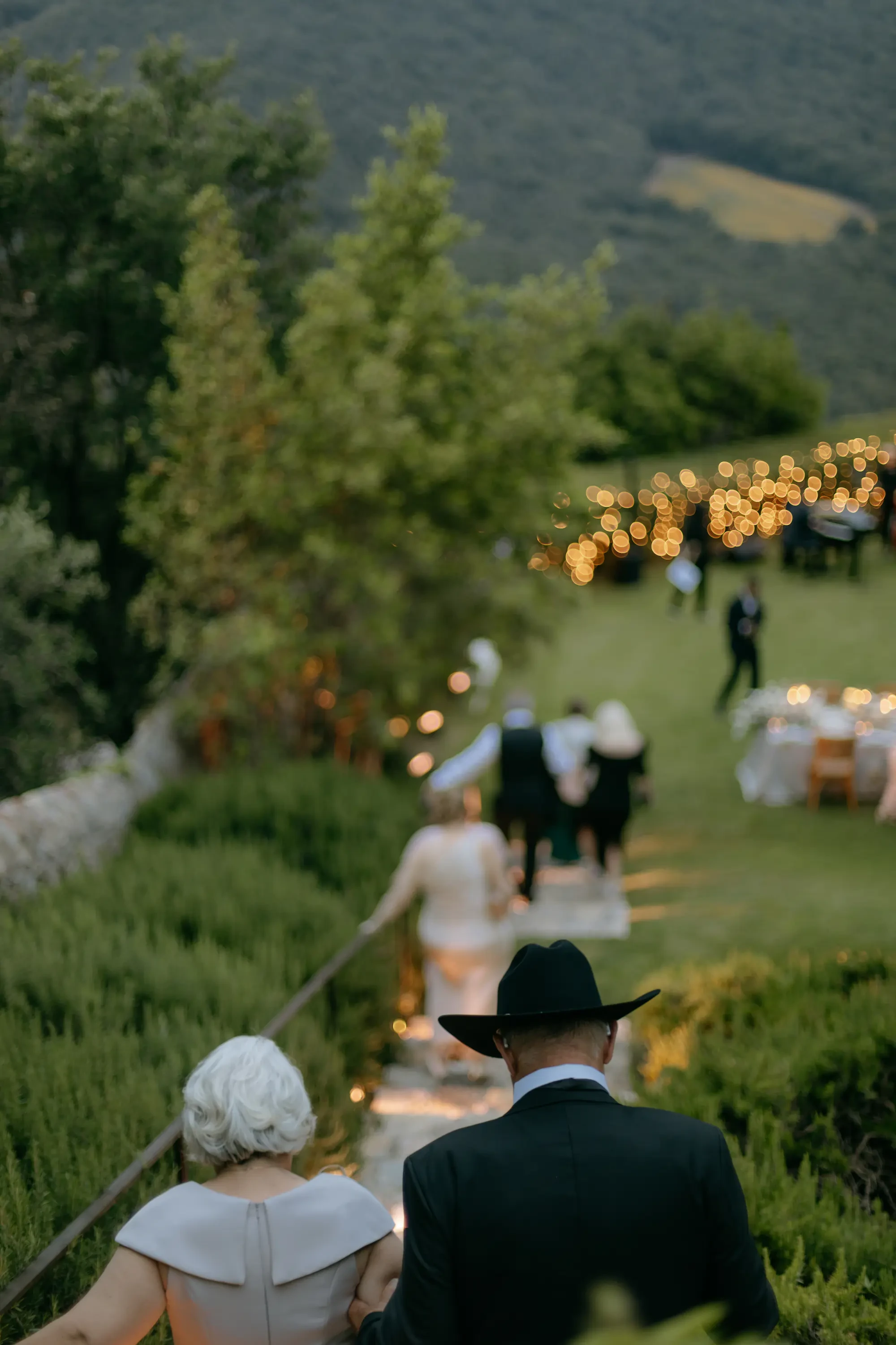 Wedding Guests Walking Down Outdoor Stairs At Twilight