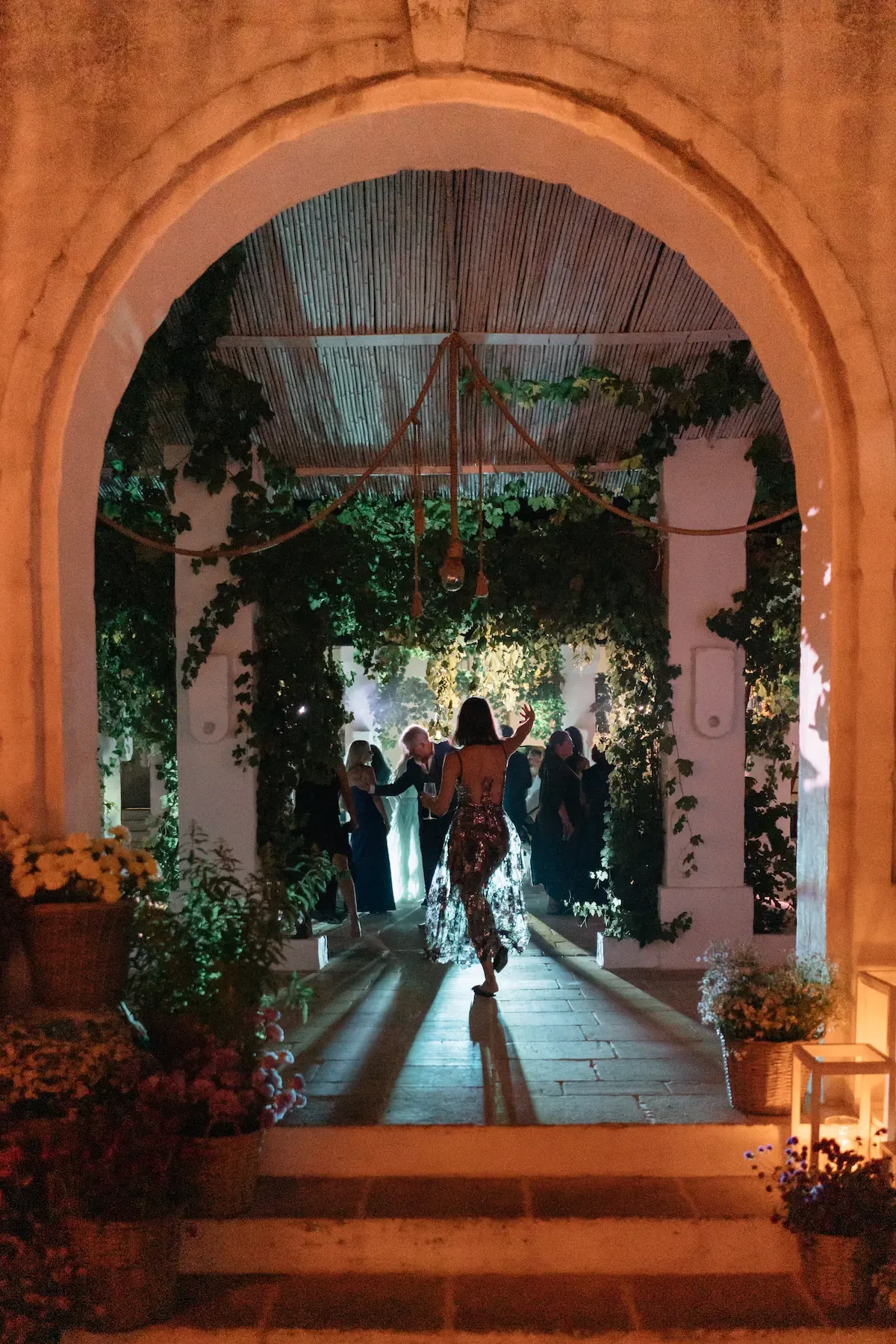 Wedding Guest Dancing Under Stone Archway Night Party